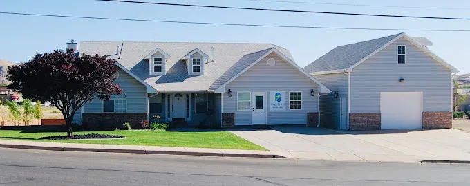 Rehab facility with sunrise sky and large driveway