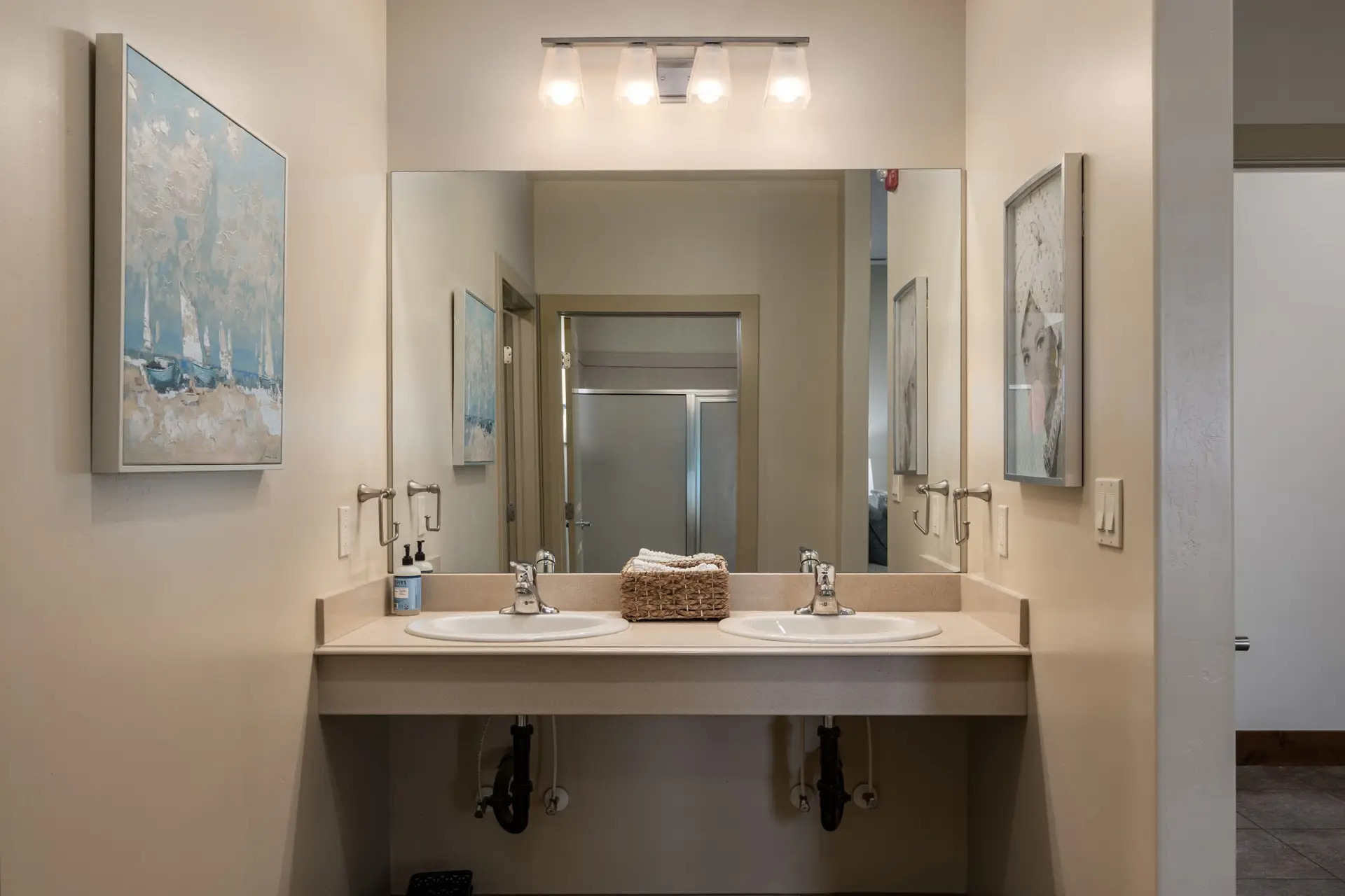 Double sink vanity with mirror and wall art