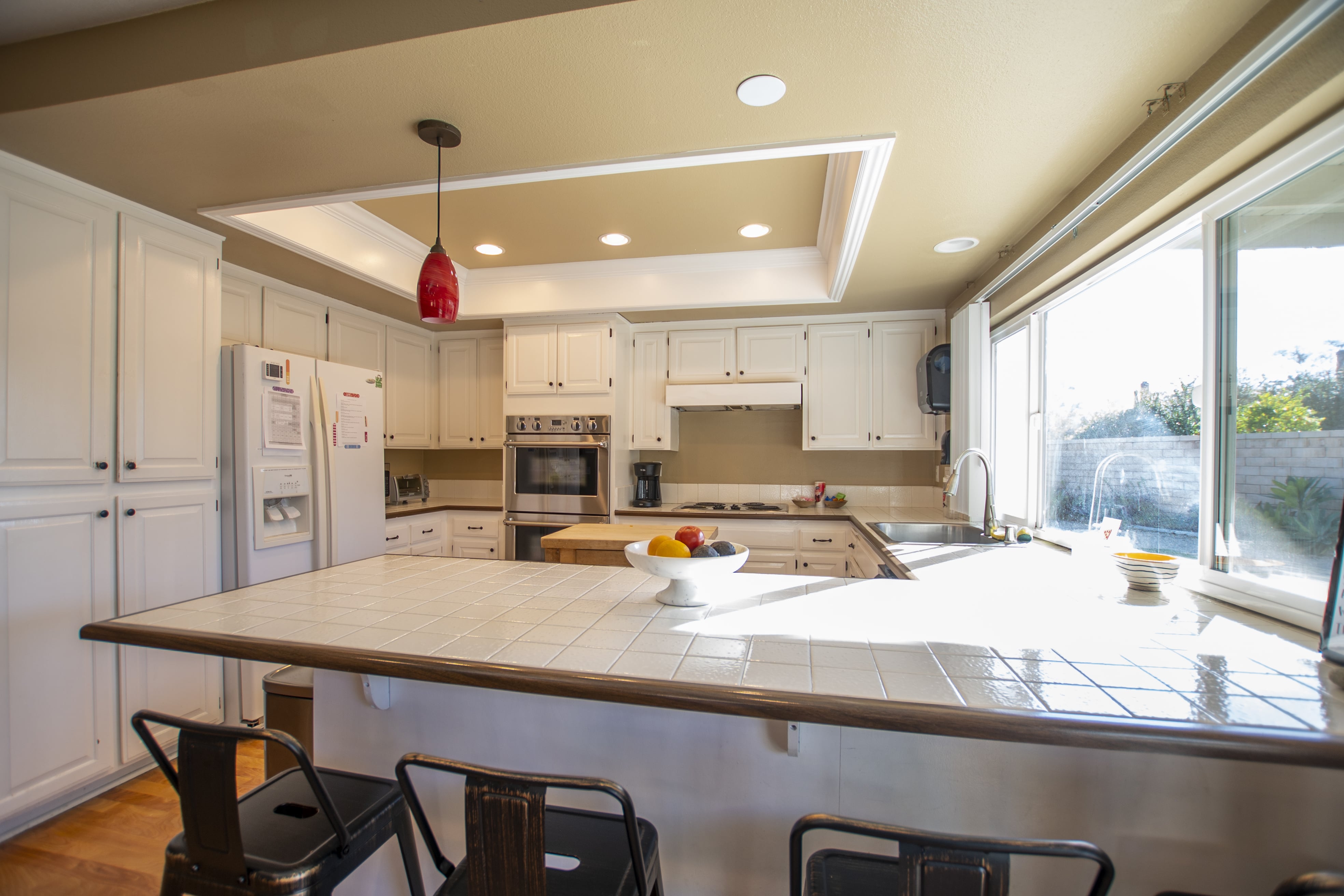 Spacious kitchen with white cabinets and island