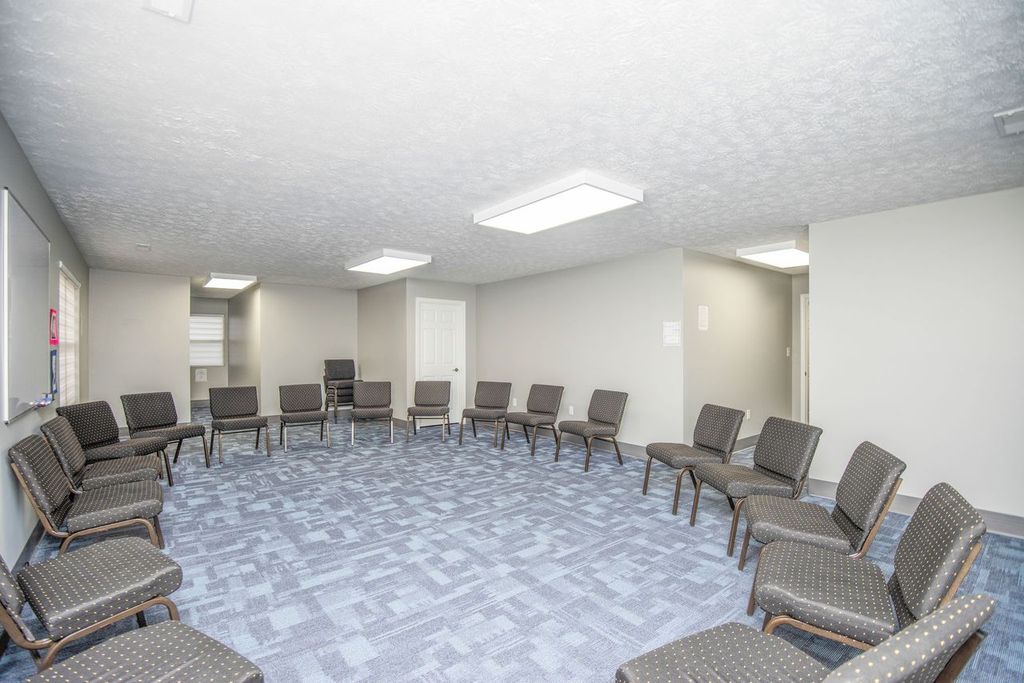 Large group therapy room with chairs arranged in a circle