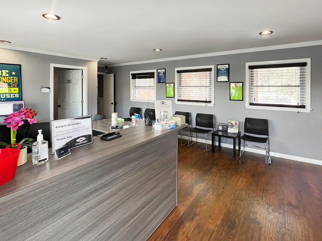 Reception desk with chairs and windows in clinic waiting room