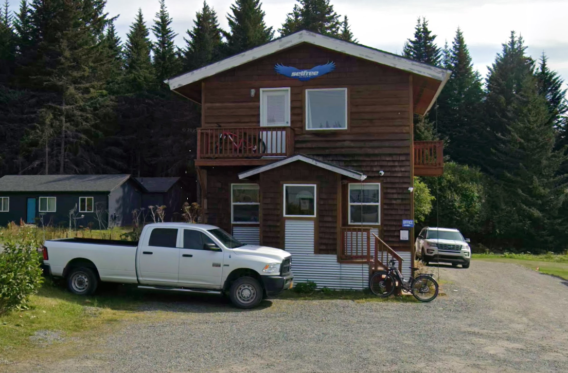 Exterior of Set Free Alaska Compass residential facility surrounded by trees