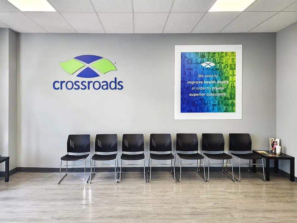 Waiting room with chairs and Crossroads clinic logo wall