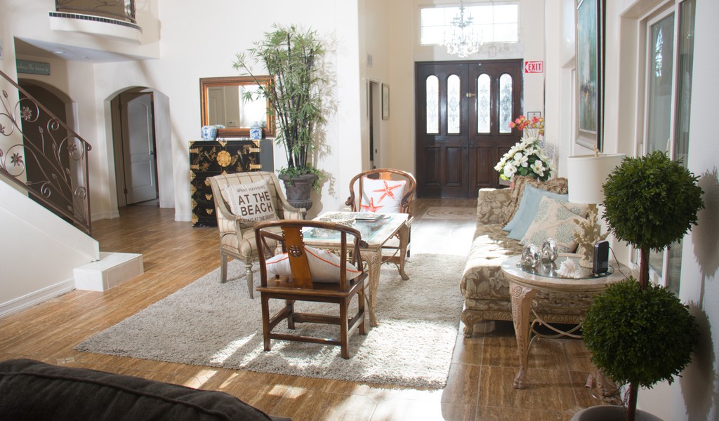 Elegant entryway with coastal decor and natural lighting.