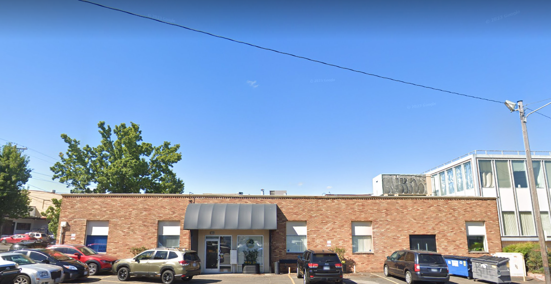 Front view of the facility with a landscaped path.