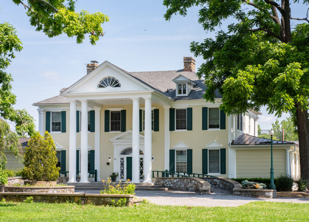 Colonial-style treatment facility with white columns and lawn