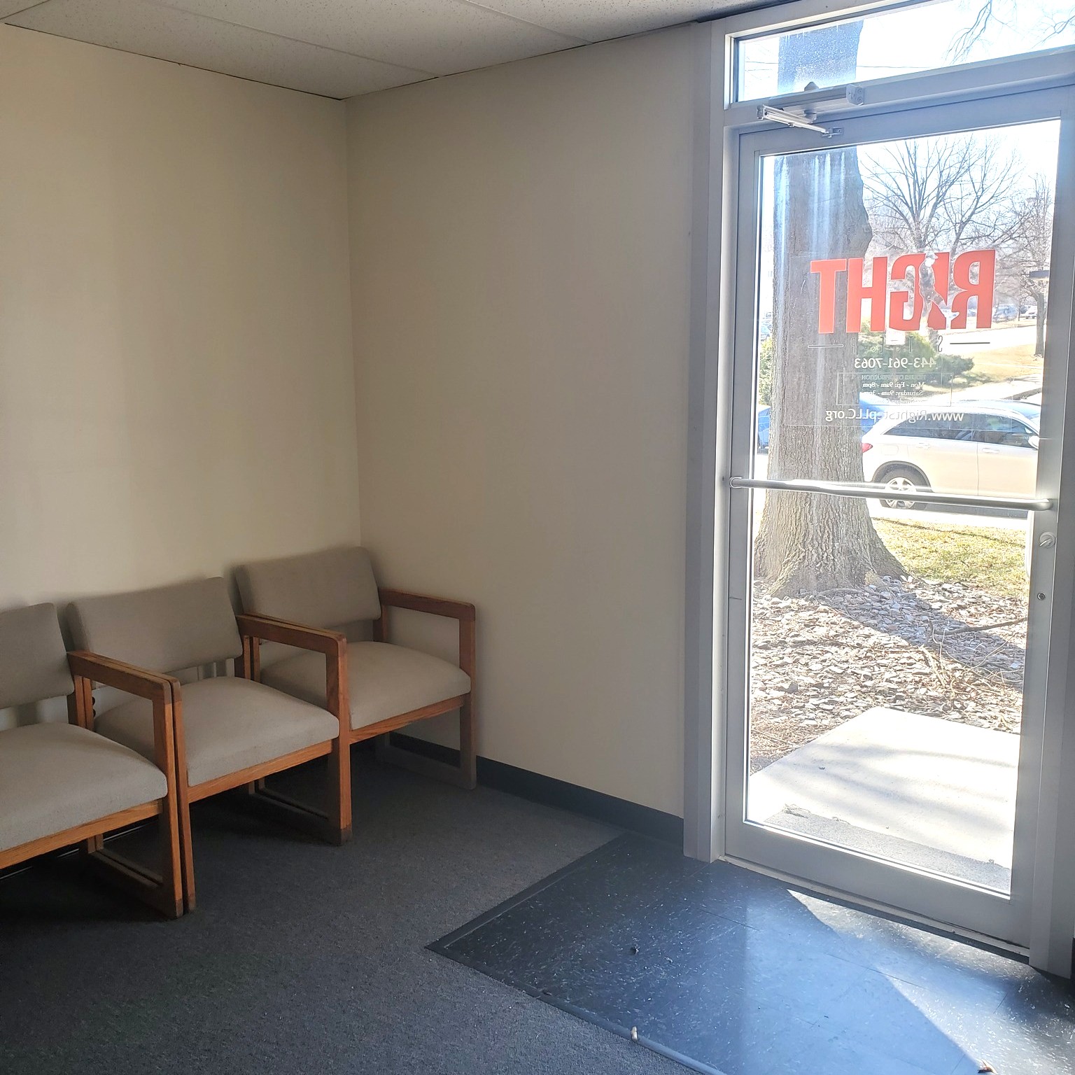 mall waiting area with chairs near glass door entrance