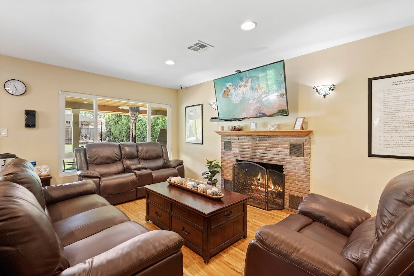 Leather sofas and fireplace with mounted TV