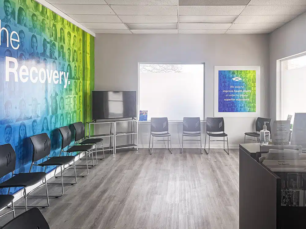 Open waiting area with chairs, TV, and wall artwork