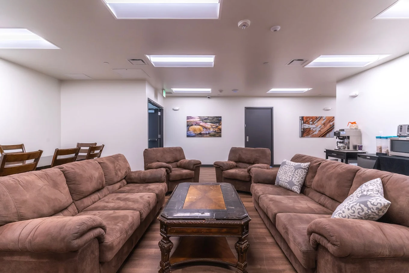 Cozy dining and lounge space with sofas and tables