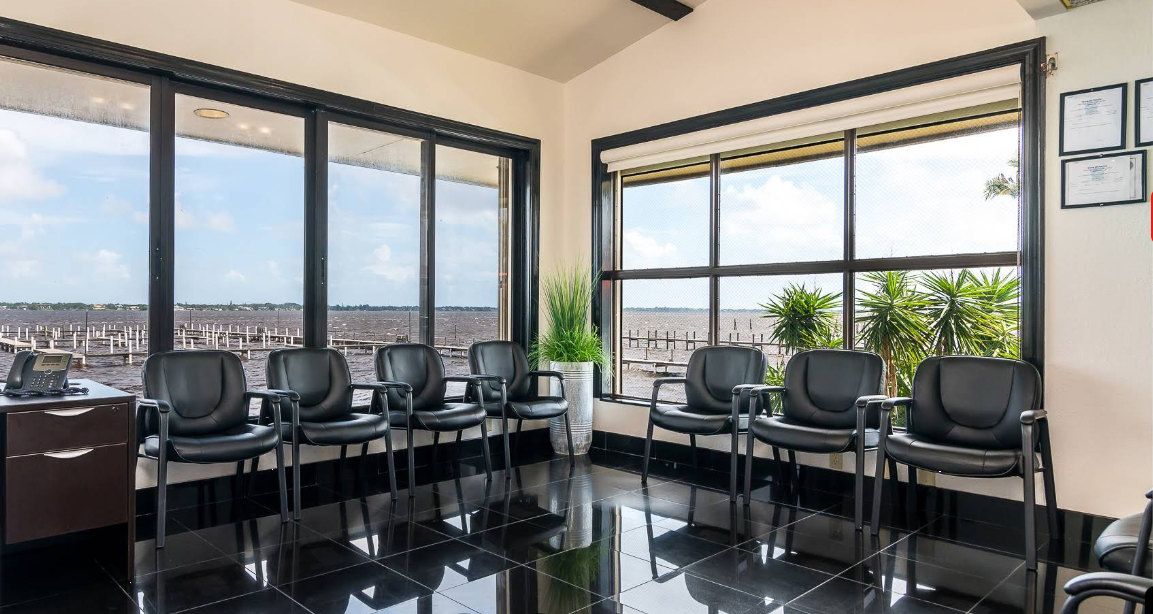 Meeting room with chairs facing large windows and water view