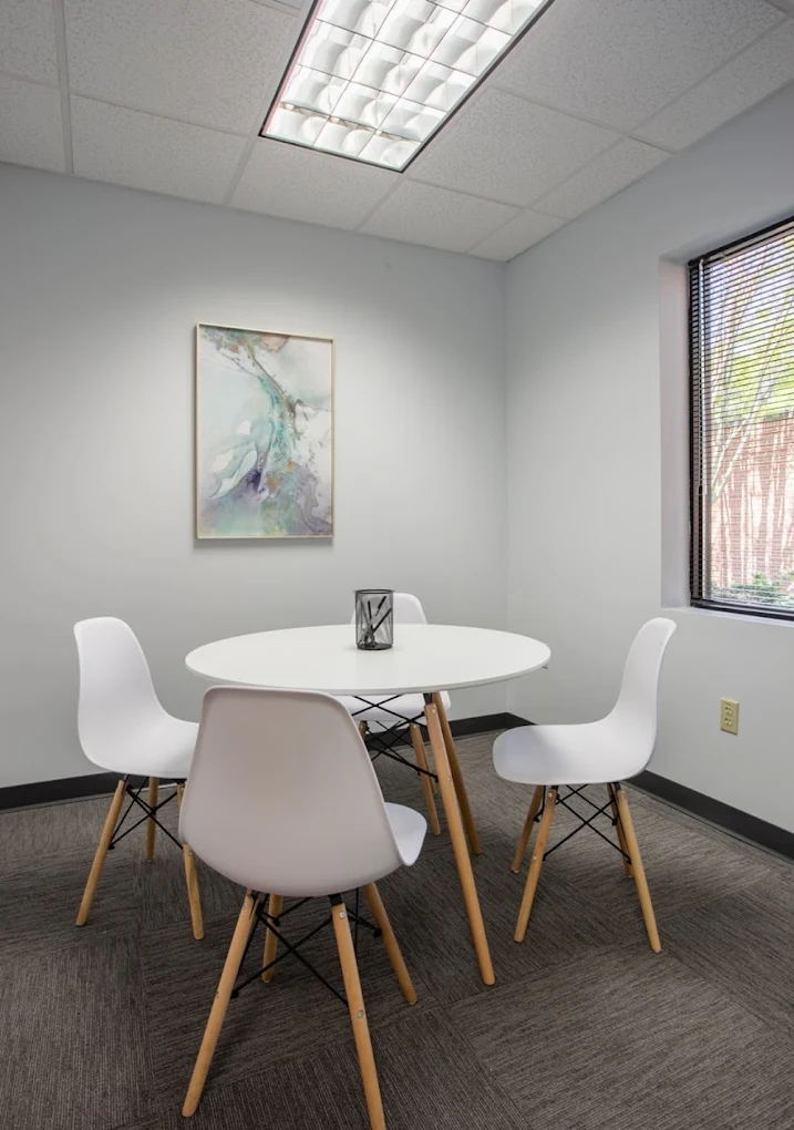 Consultation room with round table and four white chairs
