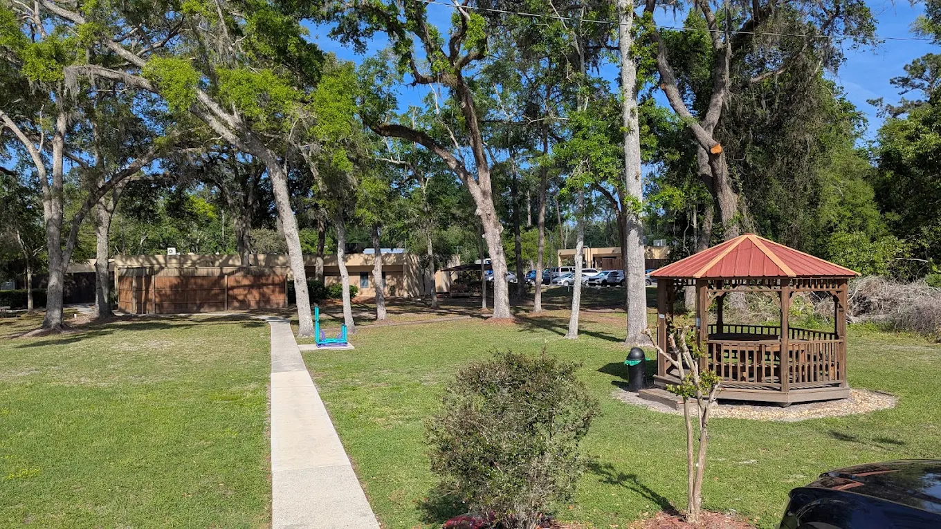 Grassy courtyard with gazebo and walking path at recovery campus