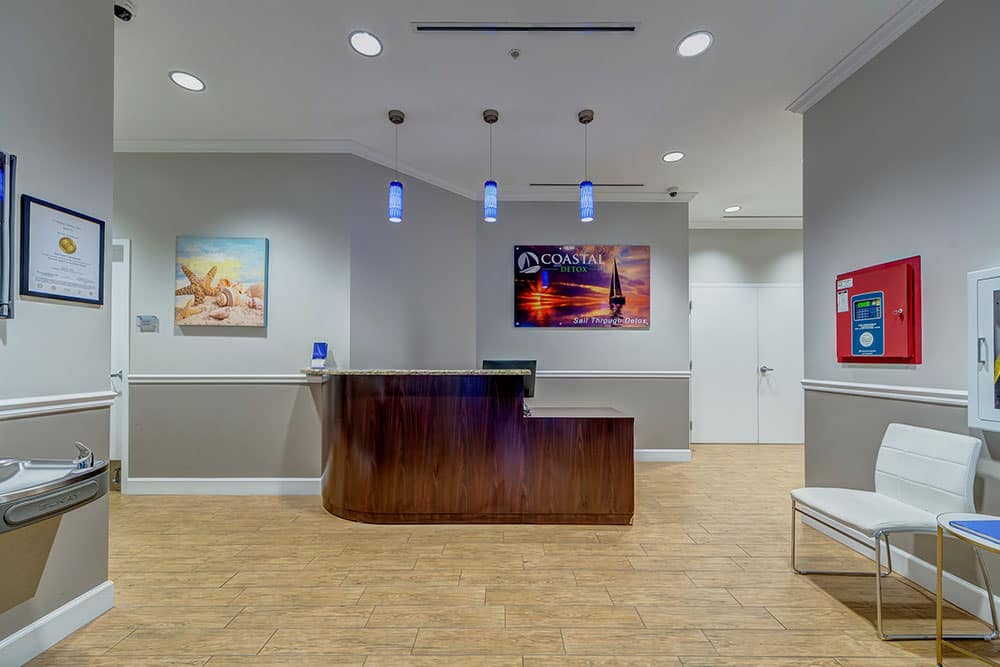 Reception counter with art and waiting chairs