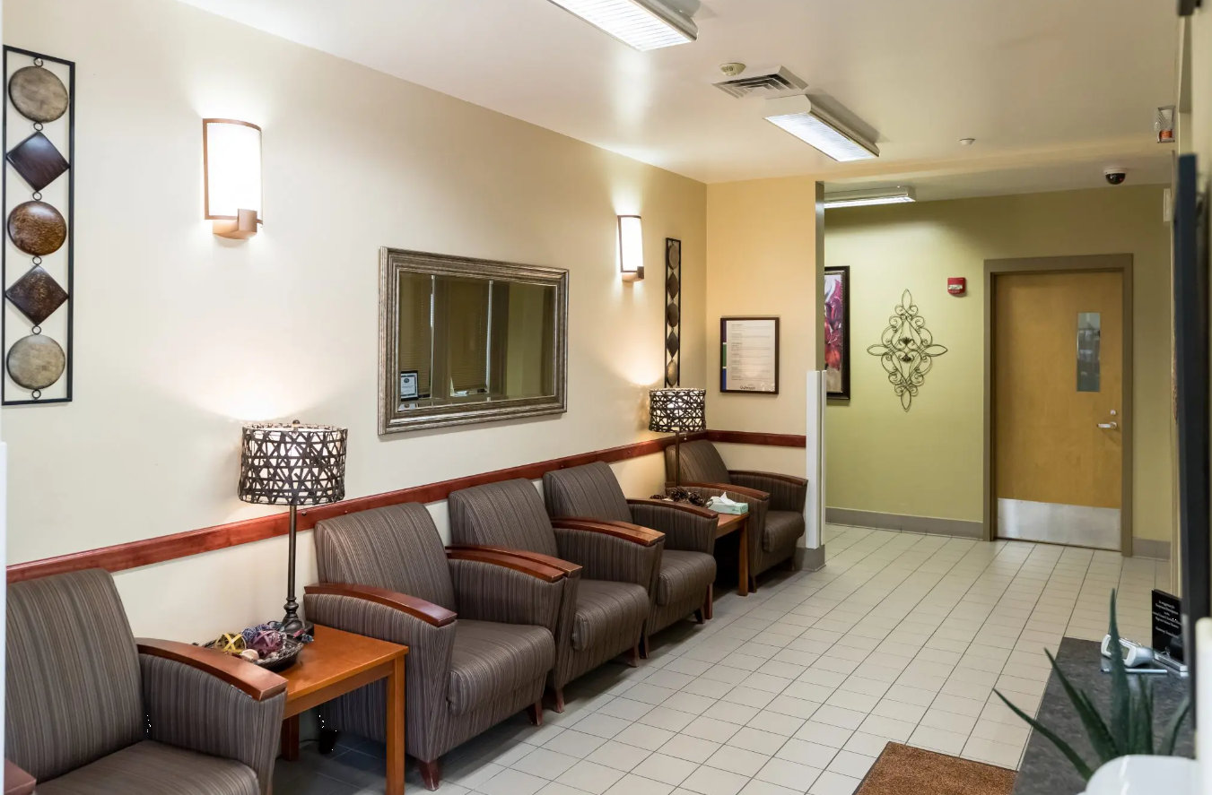 Clean waiting area with cushioned chairs and warm lighting