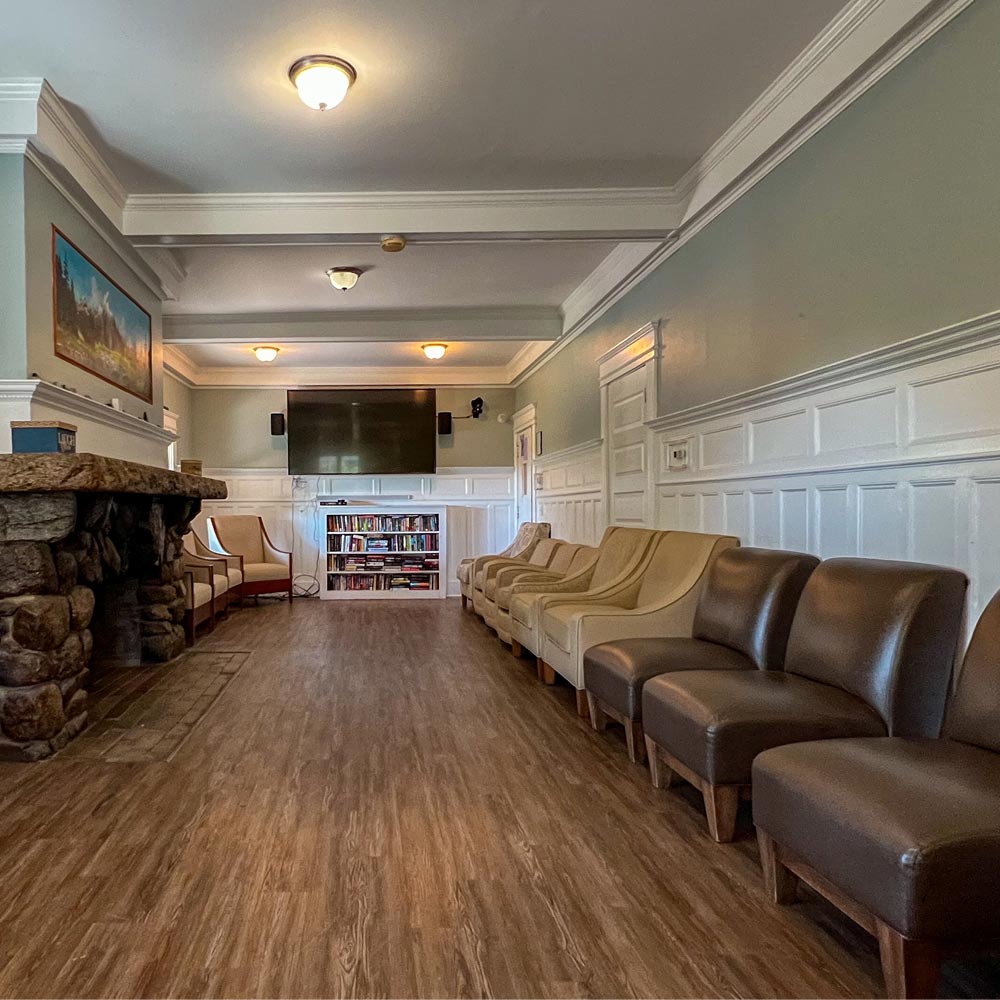 Community lounge with seating and TV at Emerson House