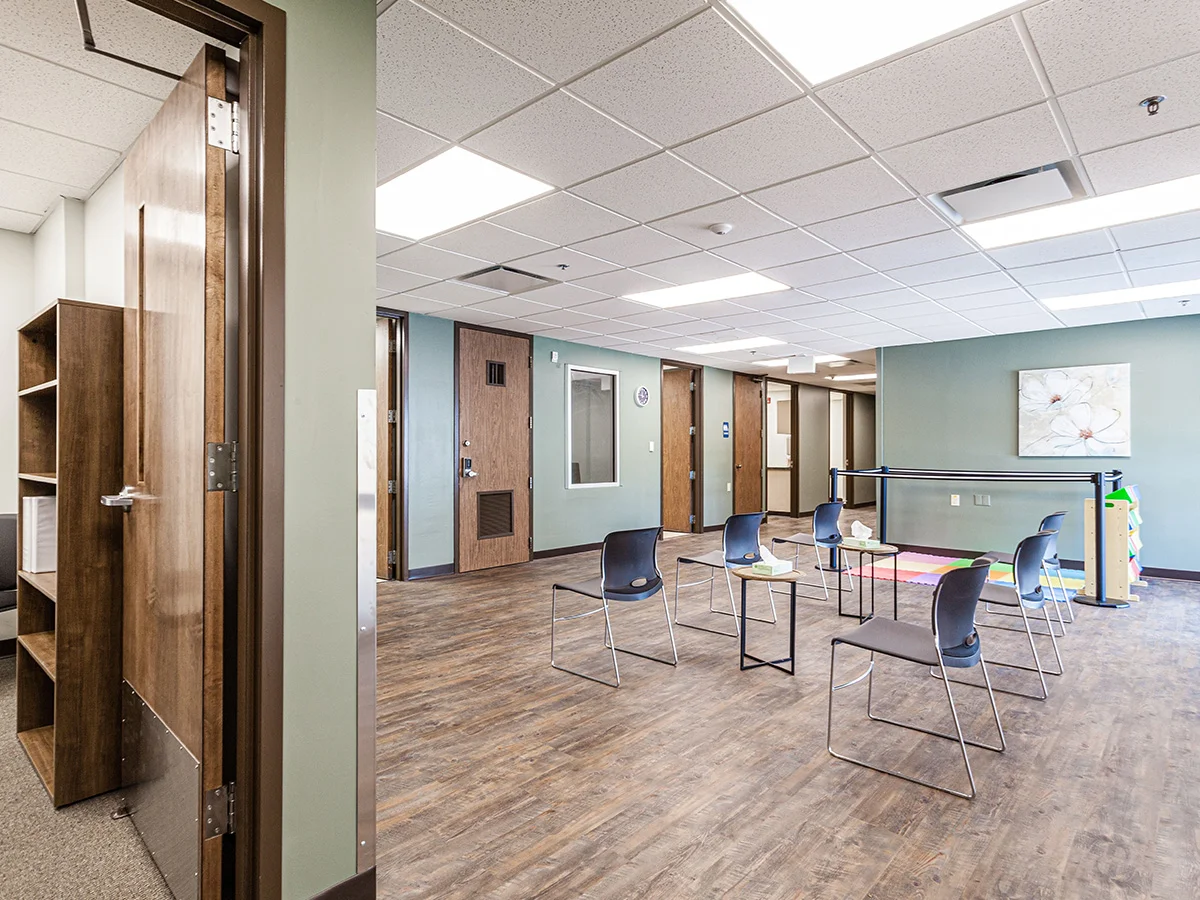 Open room with spaced chairs and therapy area