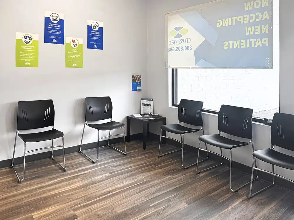 Waiting area with chairs and informational posters at center