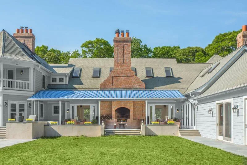 Courtyard lawn with brick fireplace and patio seating