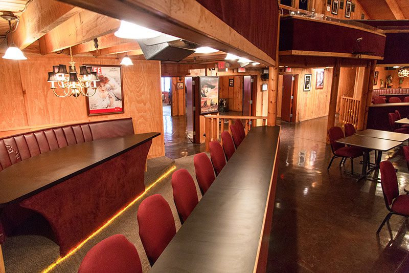 Theater room with tables, seating, and presentation space