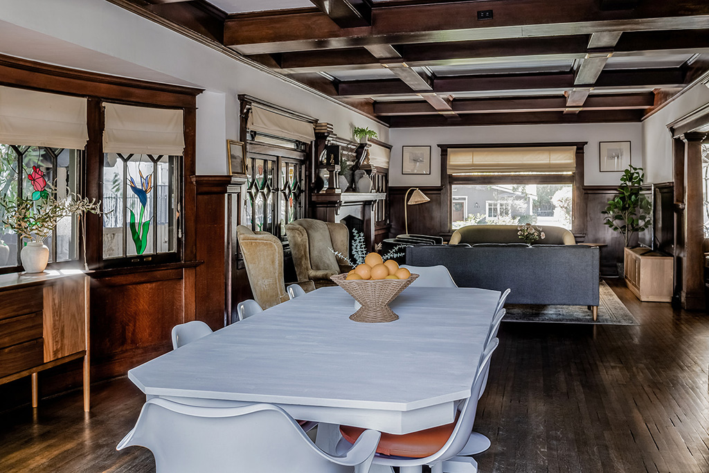 Open dining area with white table and wooden interior design