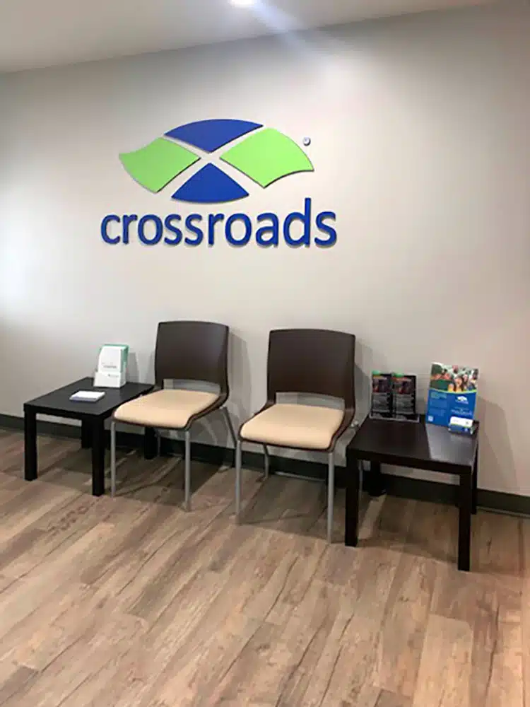 Crossroads treatment center waiting area with logo wall