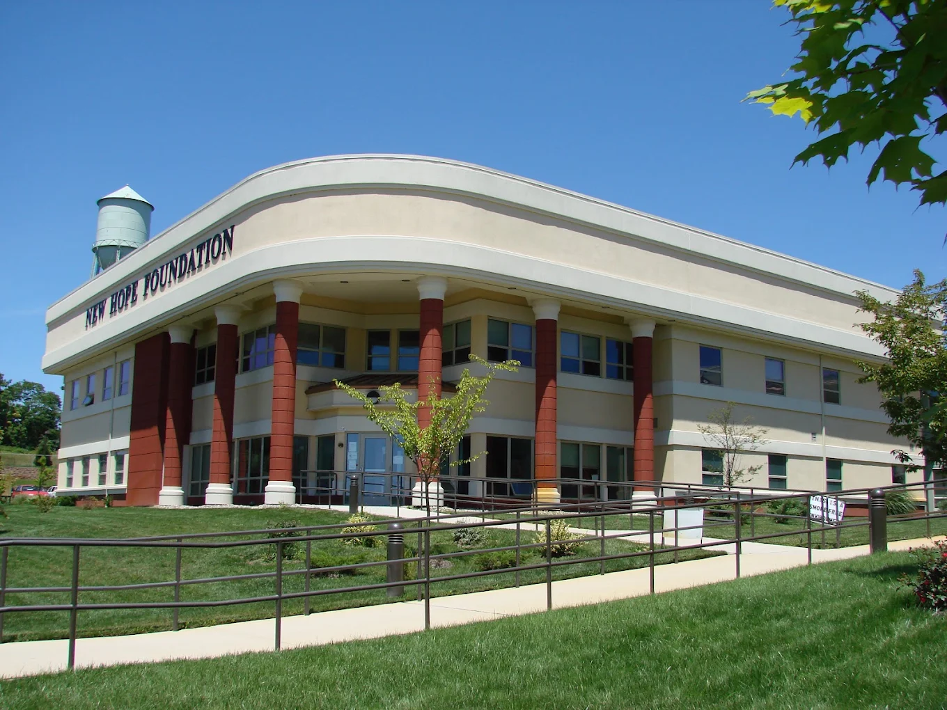 Large treatment facility exterior with pathway and lawn