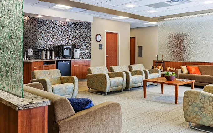 Comfortable seating area with coffee bar and soft lighting