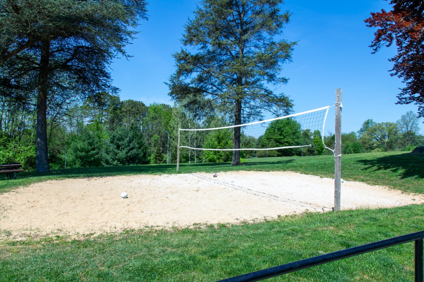 Outdoor sand volleyball court on landscaped grounds at addiction treatment center