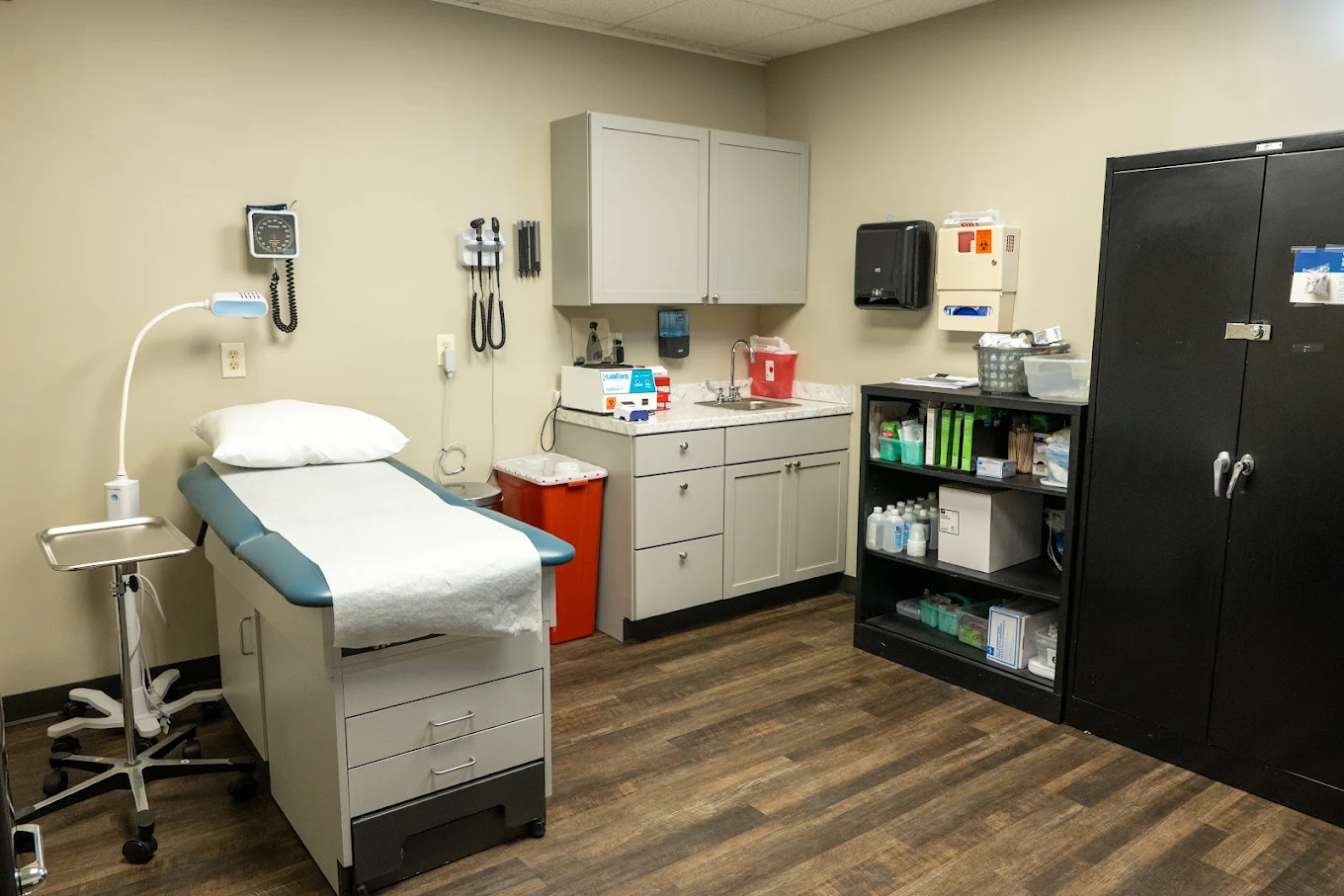 Medical exam room with exam table and clinical supplies