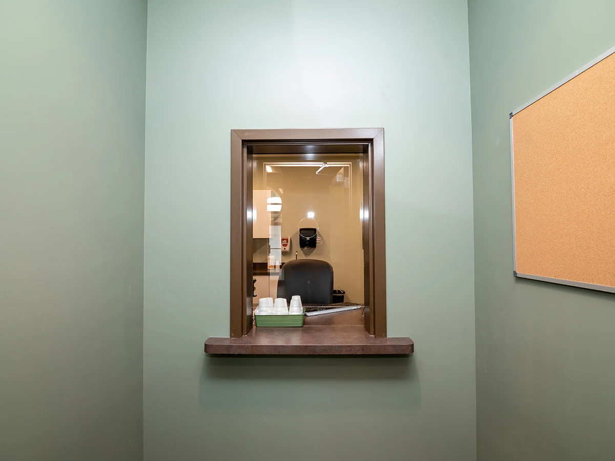 Reception window with counter and staff workspace