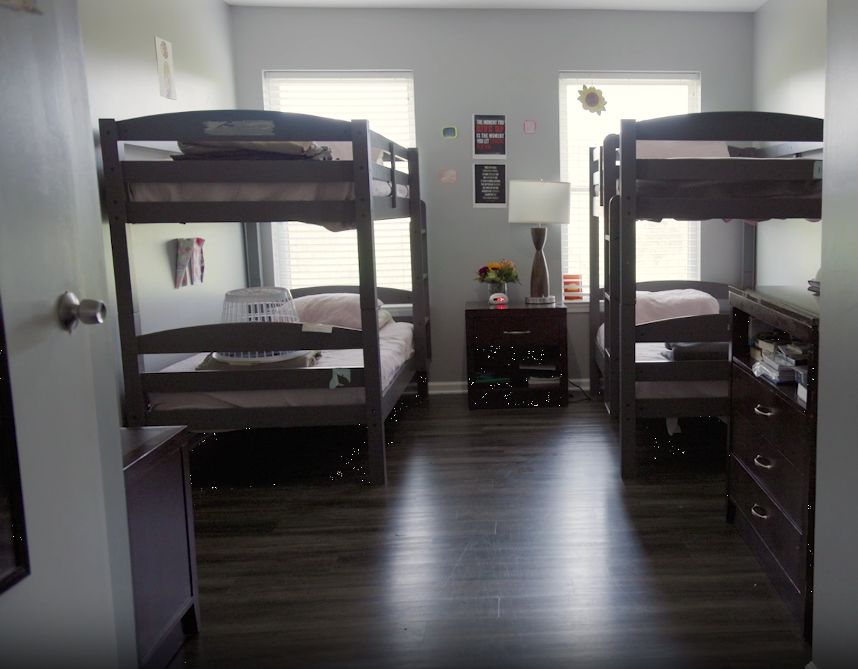 Shared bedroom with bunk beds and personal storage in residential facility