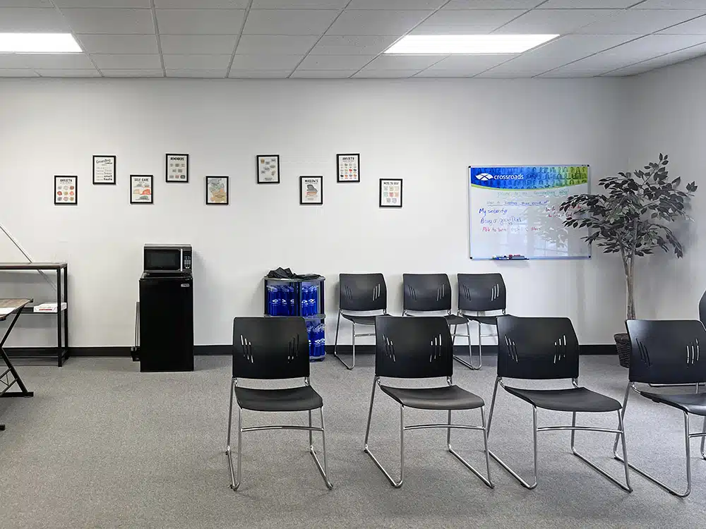 Group therapy waiting room with chairs and whiteboard