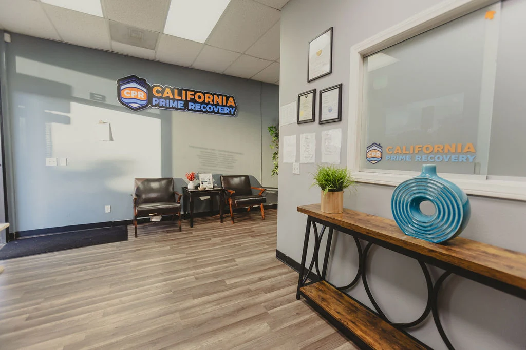 Reception area with office entrance, console table, and decor
