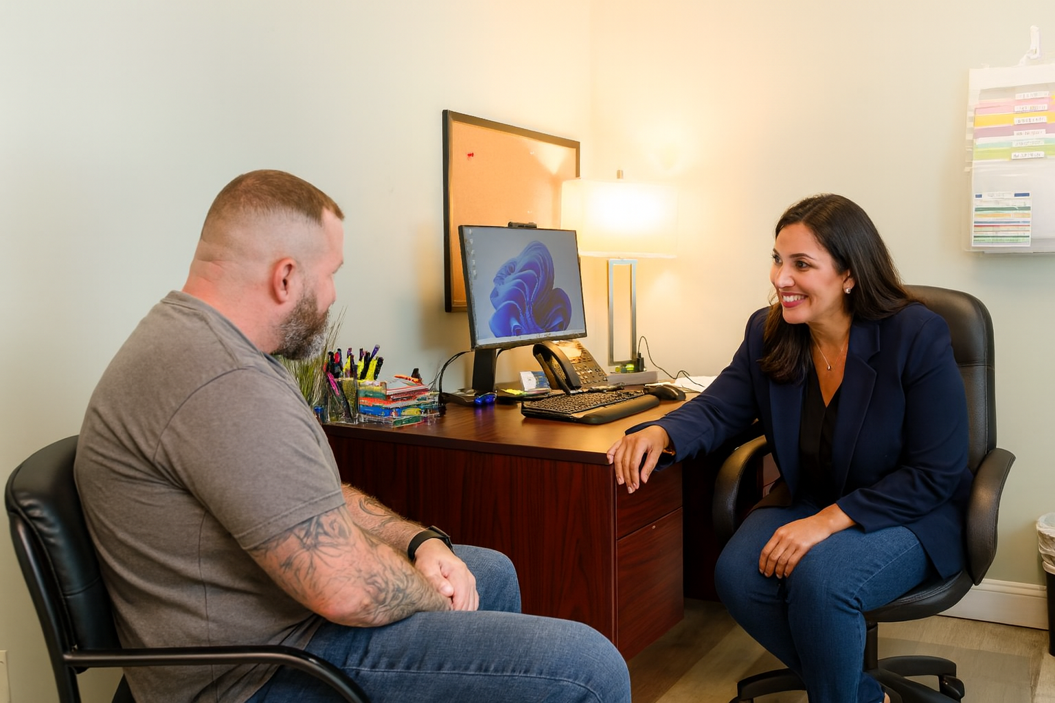 Counselor speaking with a client in a private office.