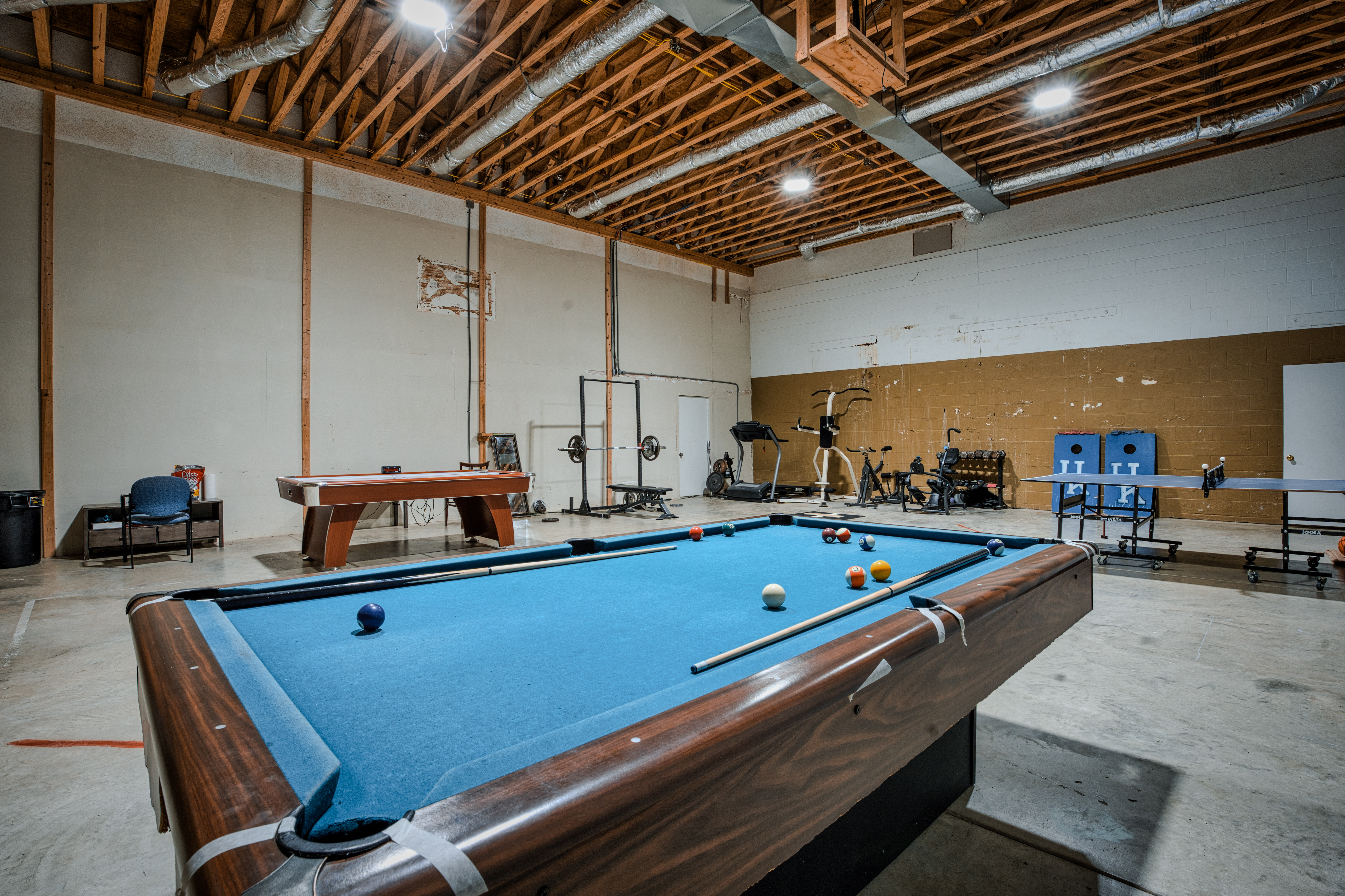 Recreation room with pool table, fitness equipment, and games