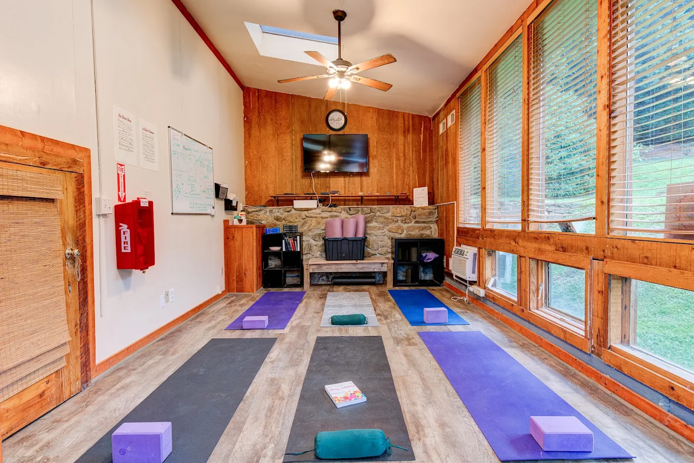 Yoga room with mats, blocks, and natural light