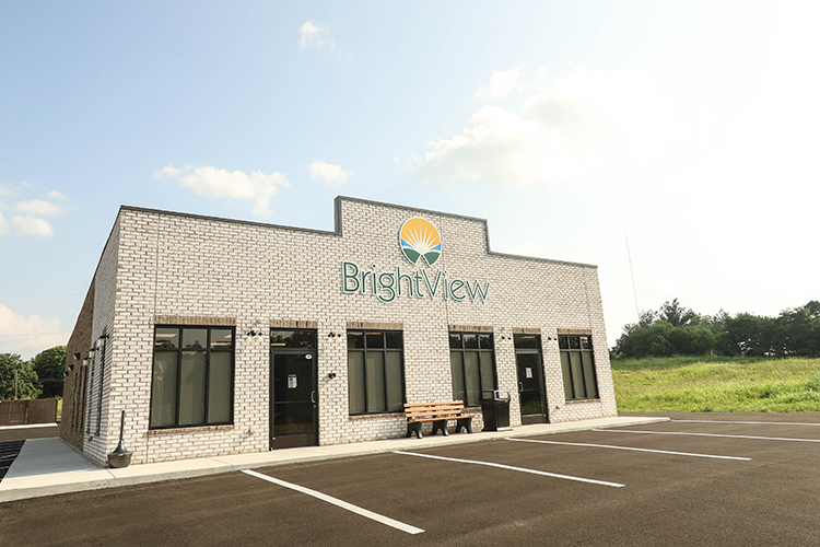 Entrance of facility with logo on the rehab center building.