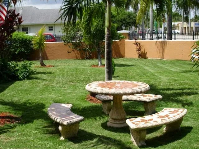 Outdoor courtyard with stone picnic table and benches at New Hope CORPS.