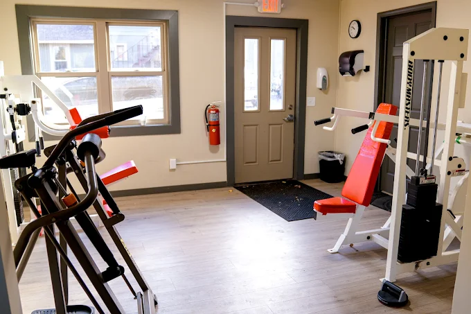Small fitness room with weight machines and cardio equipment