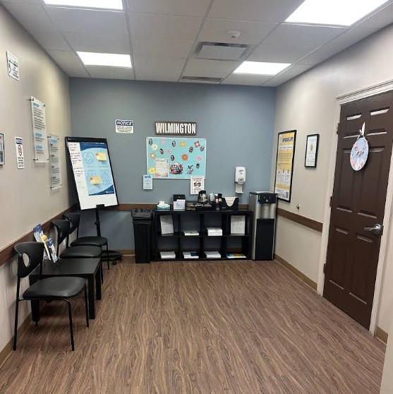 Lobby with seating, resource shelf, and beverage station