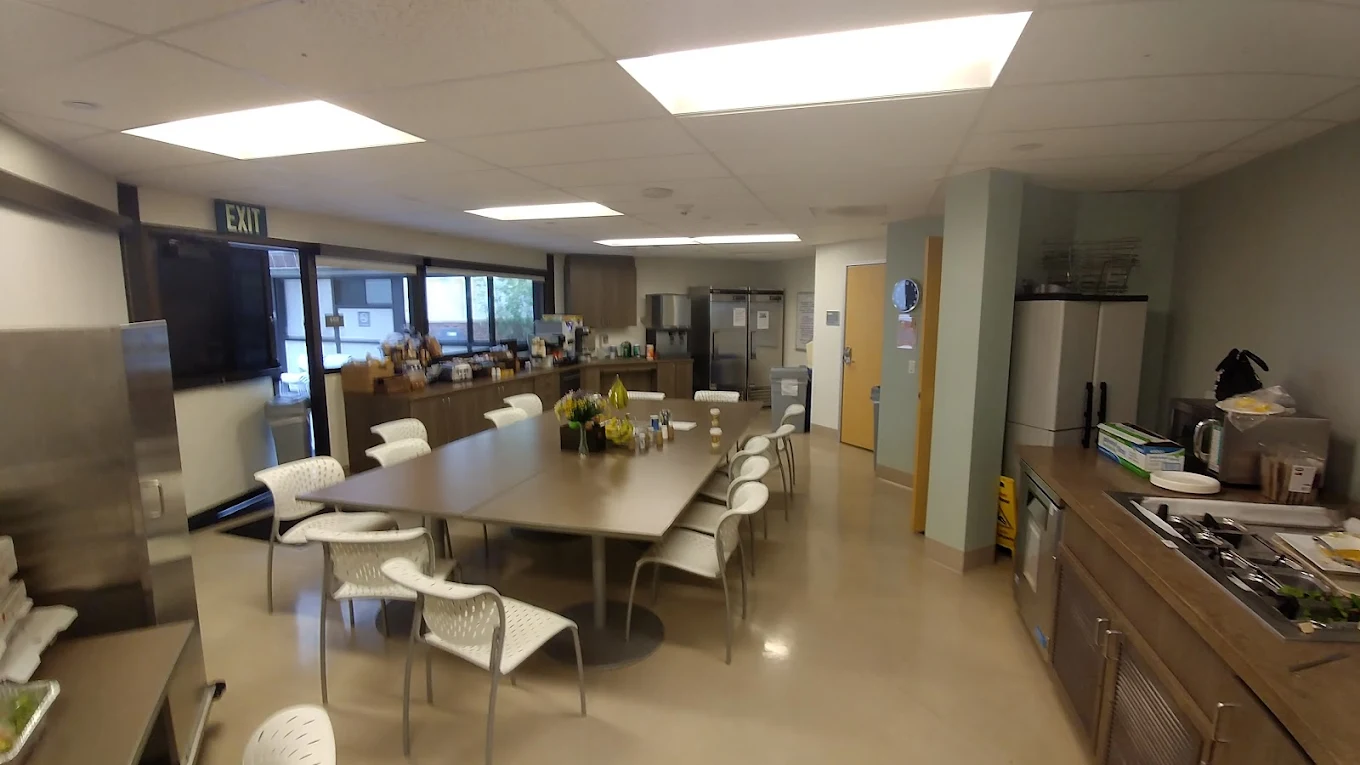 Dining area with large table and kitchen facilities