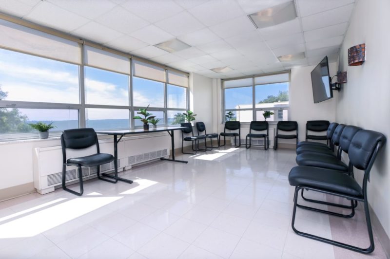 Windowed room with chairs in circle and ocean view