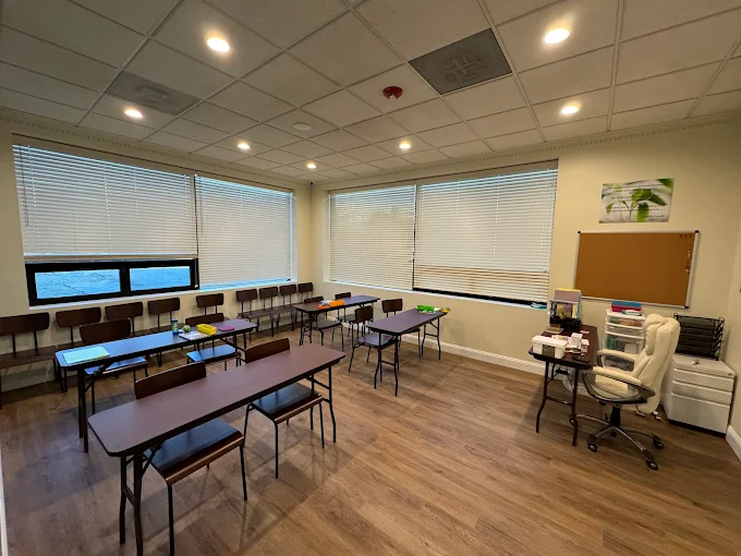 Therapy room with chairs, tables, and counselor’s desk