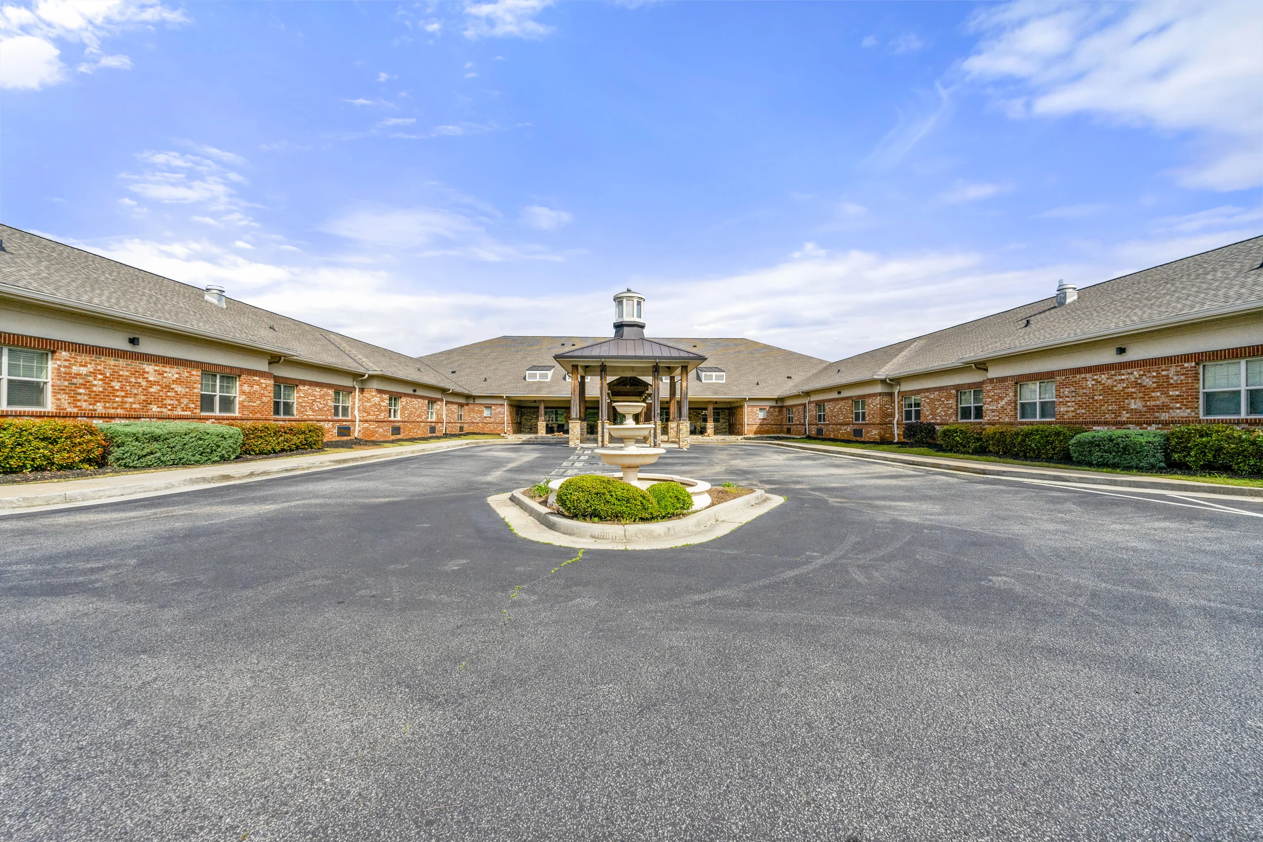 Front entrance of Promises Atlanta featuring landscaped grounds, covered porte cochère, and fountain