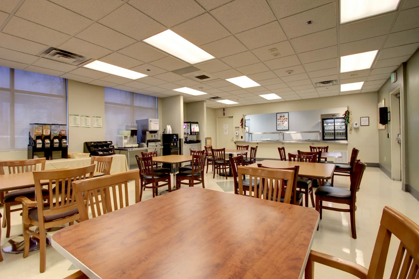 Dining hall with tables, chairs, and beverage stations.