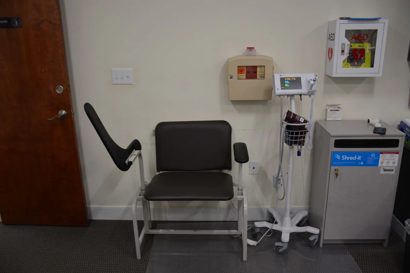 Exam room with patient chair and vital signs monitor