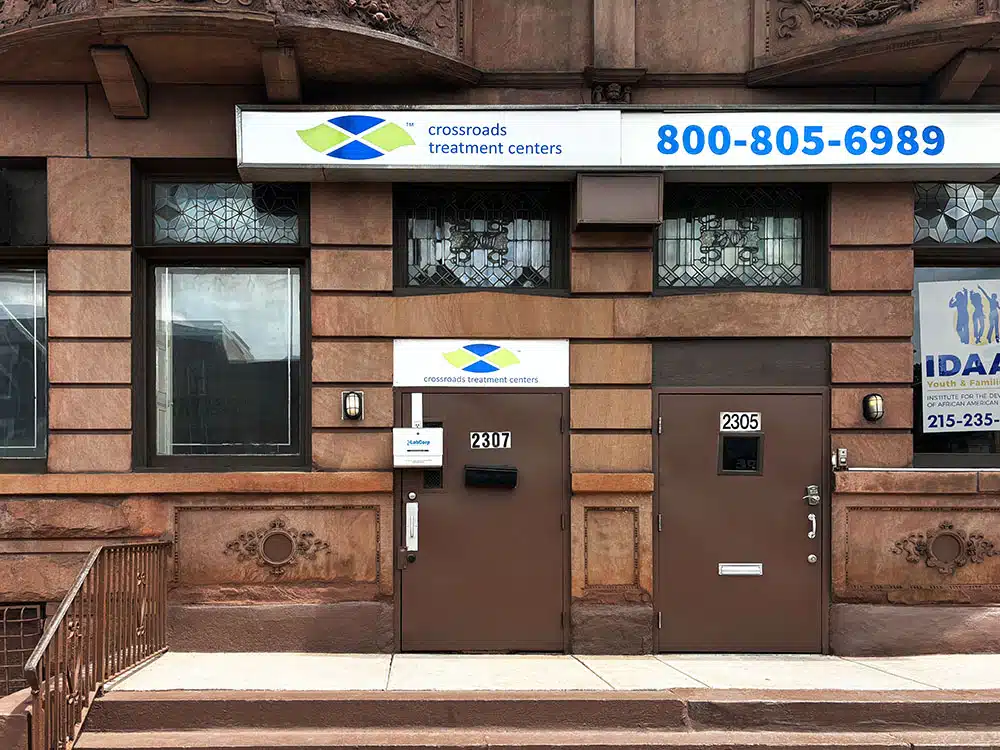 Brick building entrance with Crossroads treatment sign