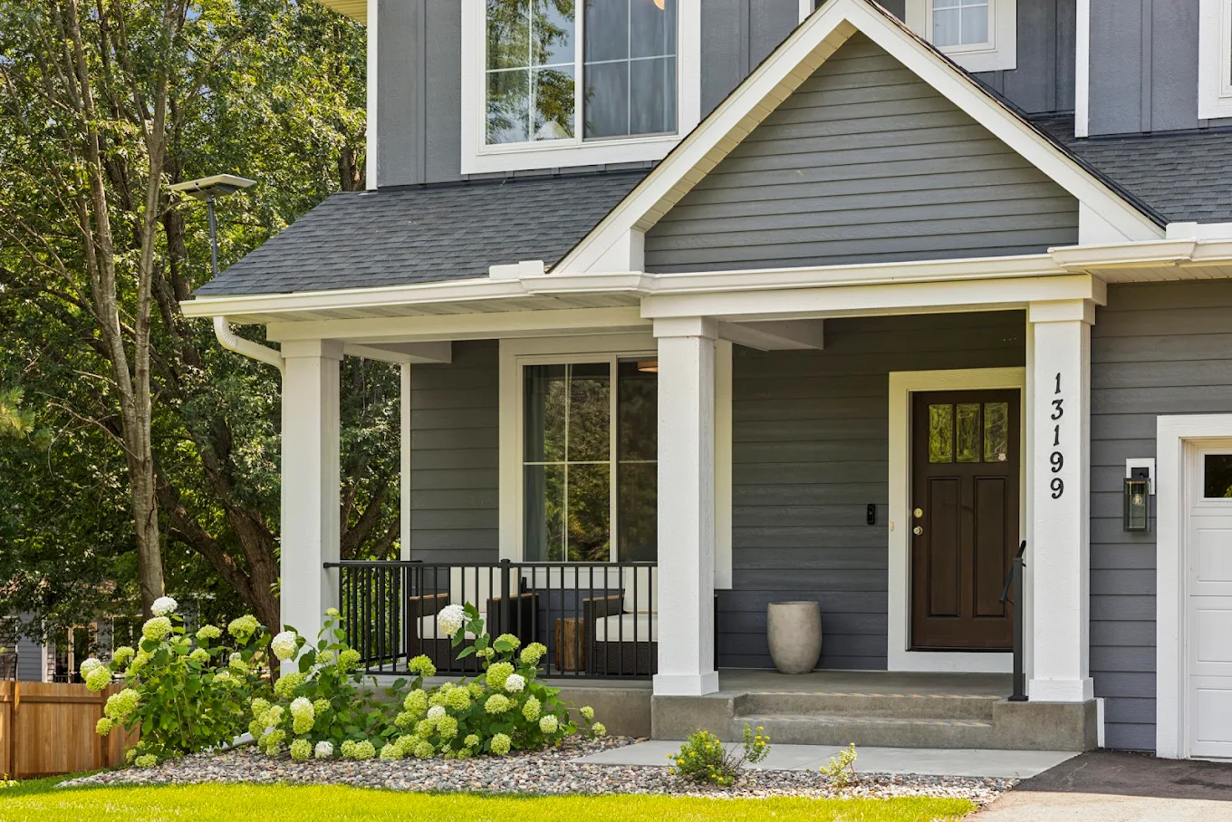 Front porch with dark door and white trim