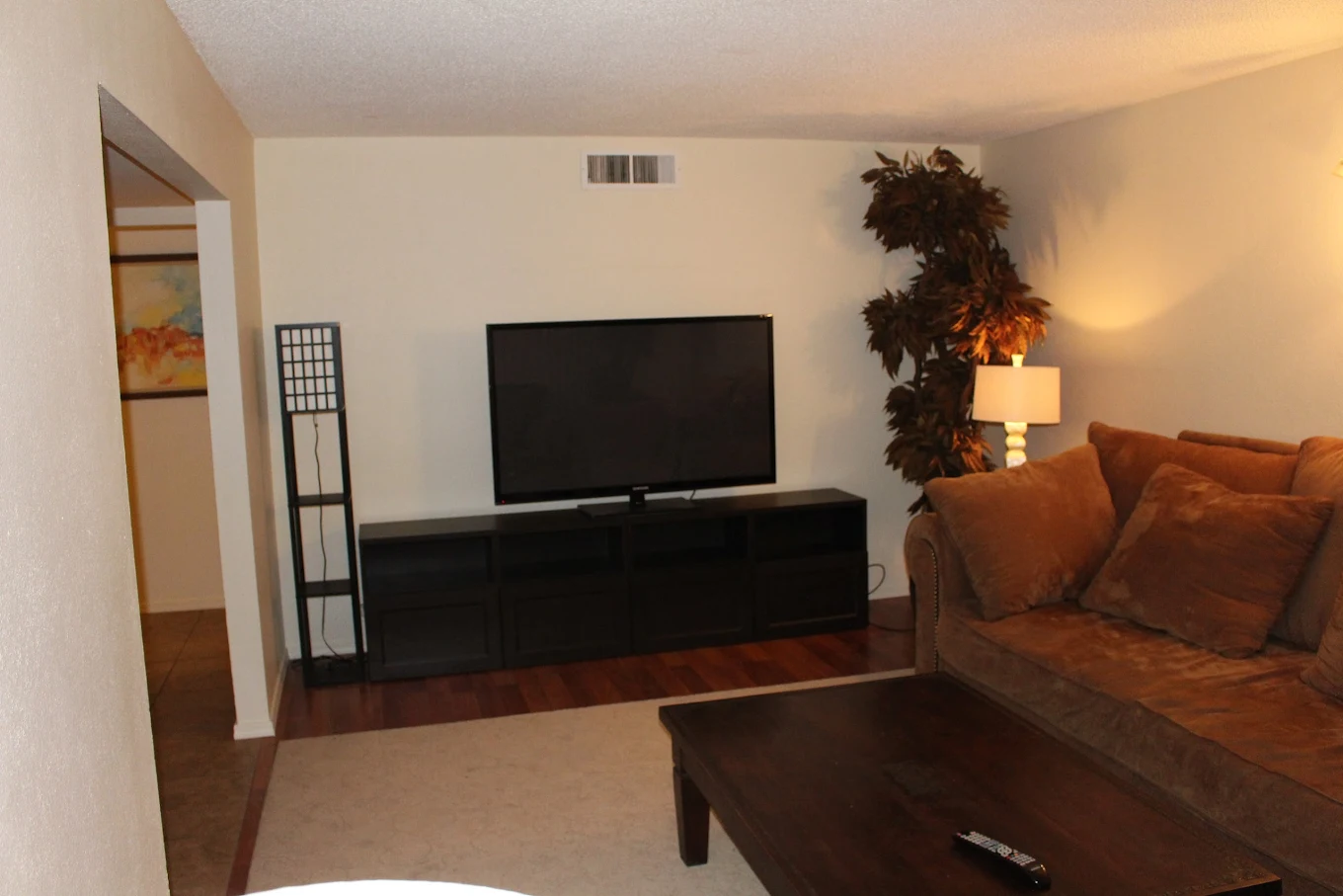TV with couch and coffee table in lounge